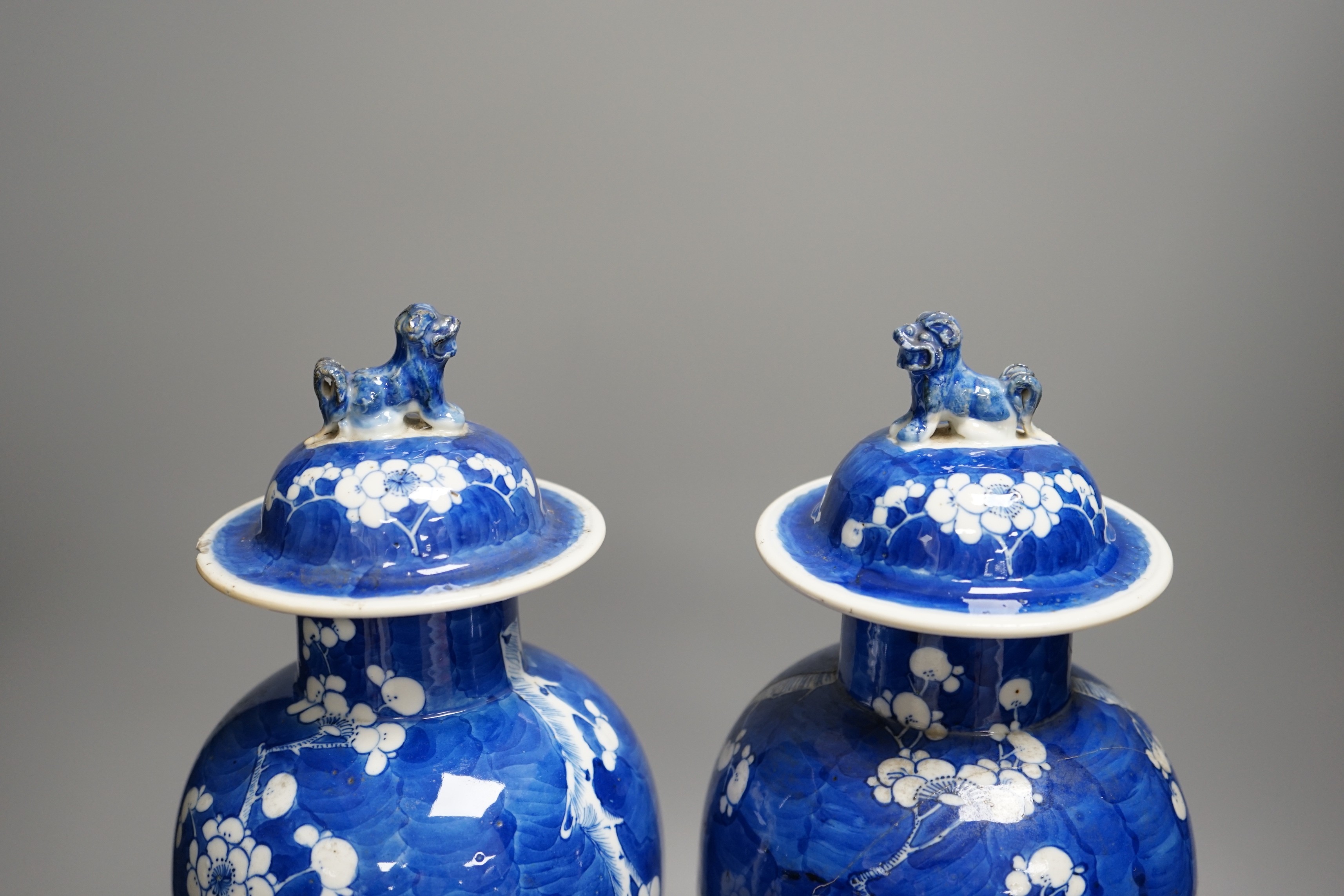 A pair of 19th century Chinese blue and white prunus vases, one a.f, 37cm